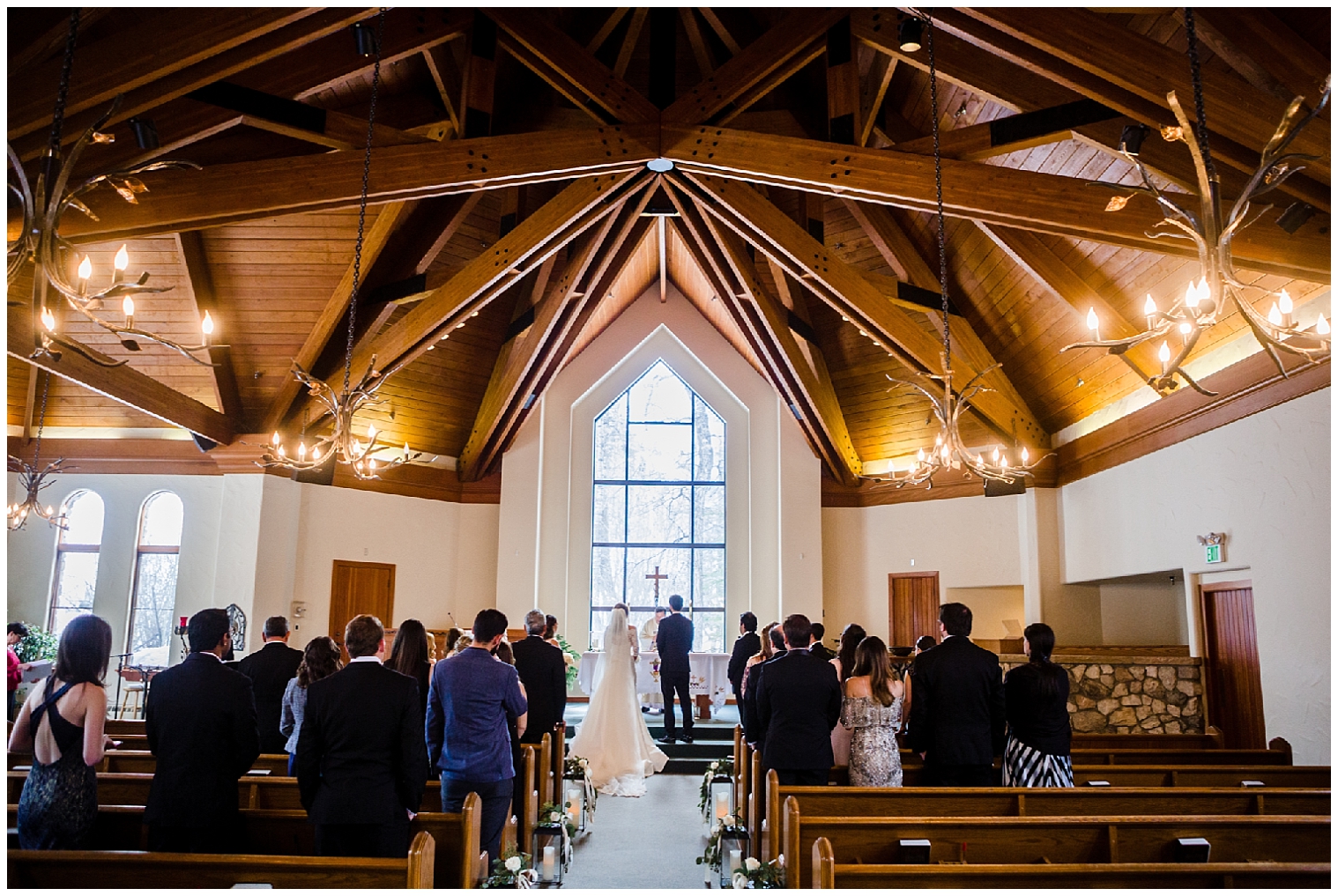 The bride and groom stand together at the altar at their beaver creek chapel church wedding.