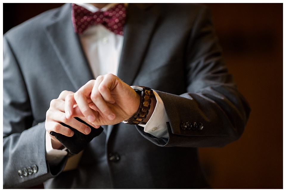 detail of groom putting on his new watch on his fall colorado wedding day
