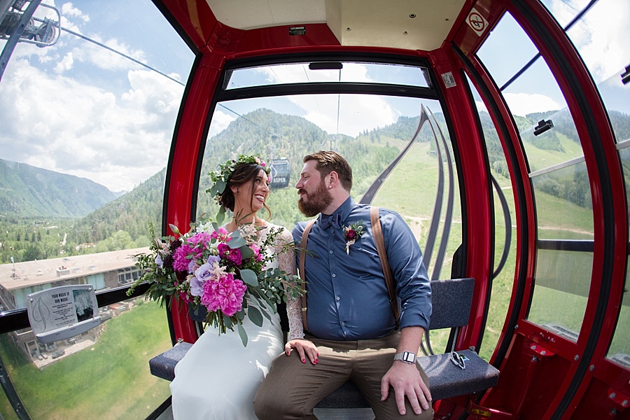 bride and groom in the ski gondola on their way to the top of aspen mountain for their elopement 