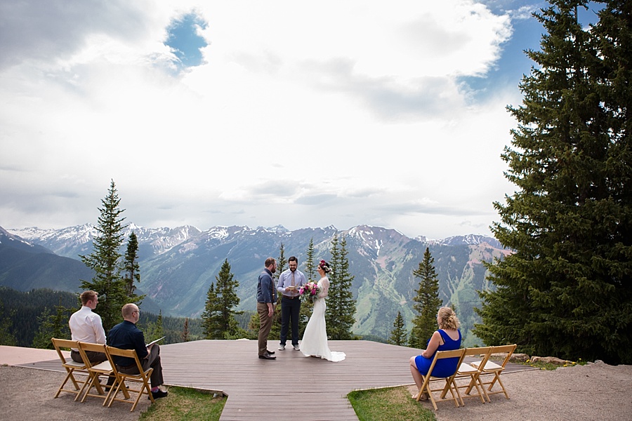 bride and groom at their elopement ceremony at little nell wedding deck in aspen