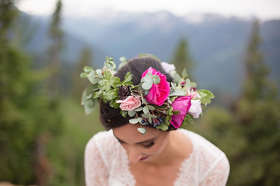 bride shows off her pink and magenta floral crown in aspen colorado 