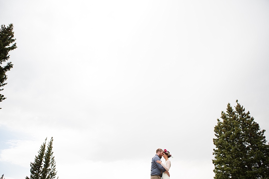 bride and groom hug in the mountains after their aspen elopement 