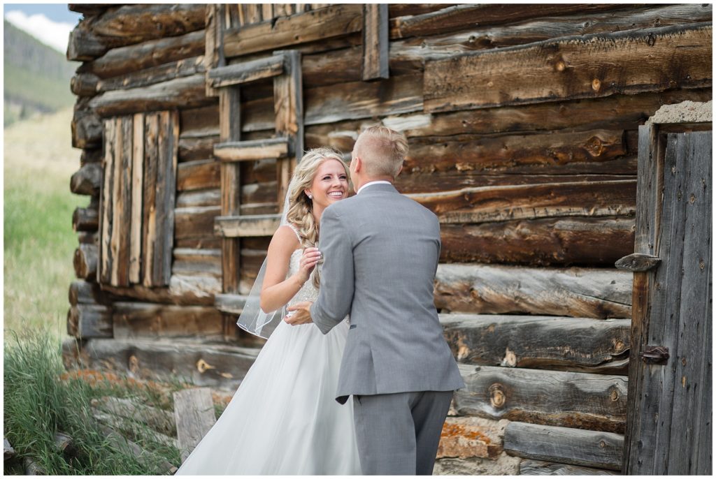 groom reacts to seeing his bride for the first time on their wedding day in keystone ranch colorado