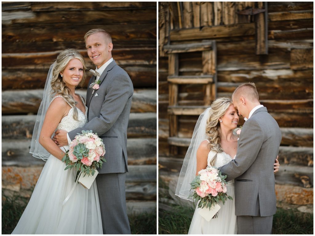bride and groom posing in front of a brown rustic barn at keystone ranch colorado