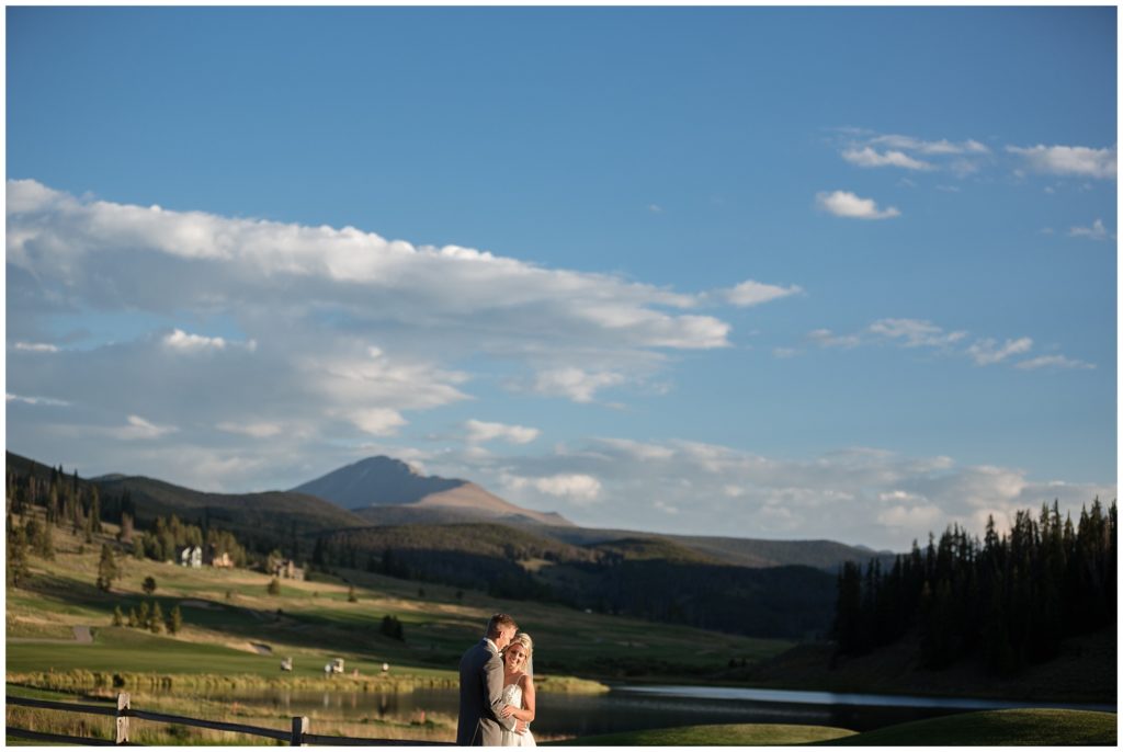 wide landscape shot with bride and groom at sunset at keystone ranch