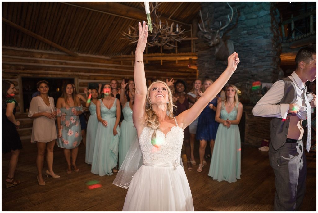 bride throwing flowers during bouquet toss