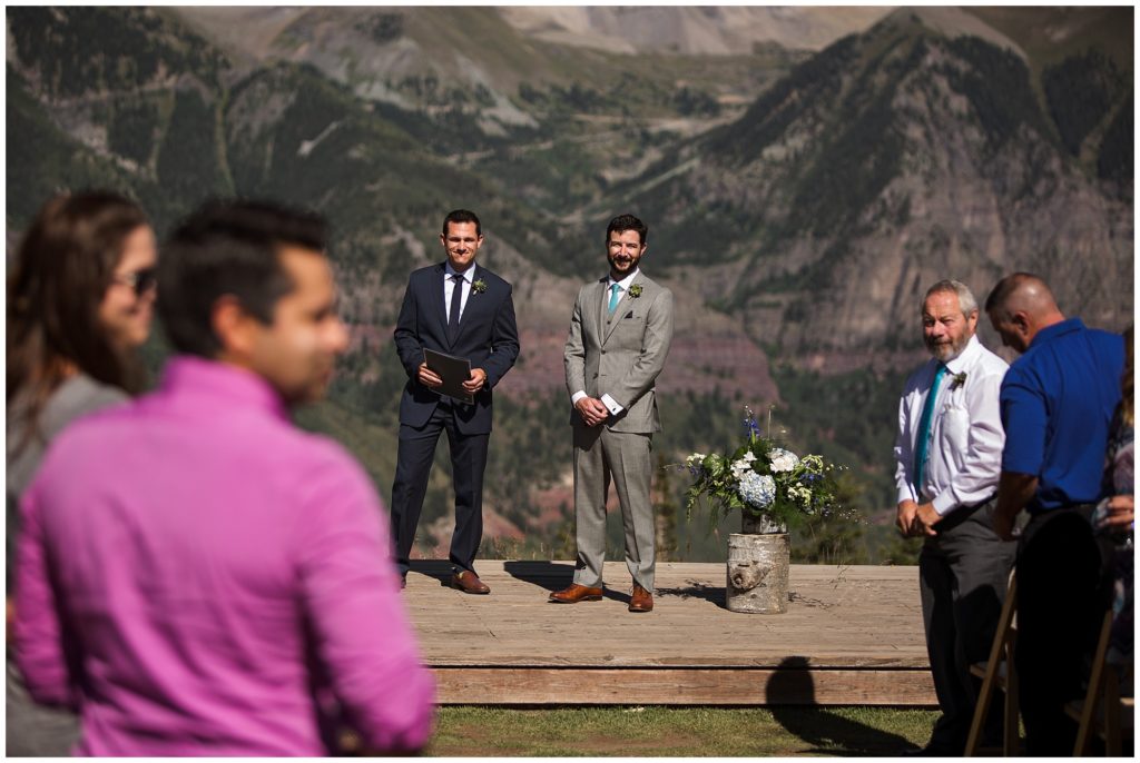 groom watches as bride walks down the aisle at gorrono ranch