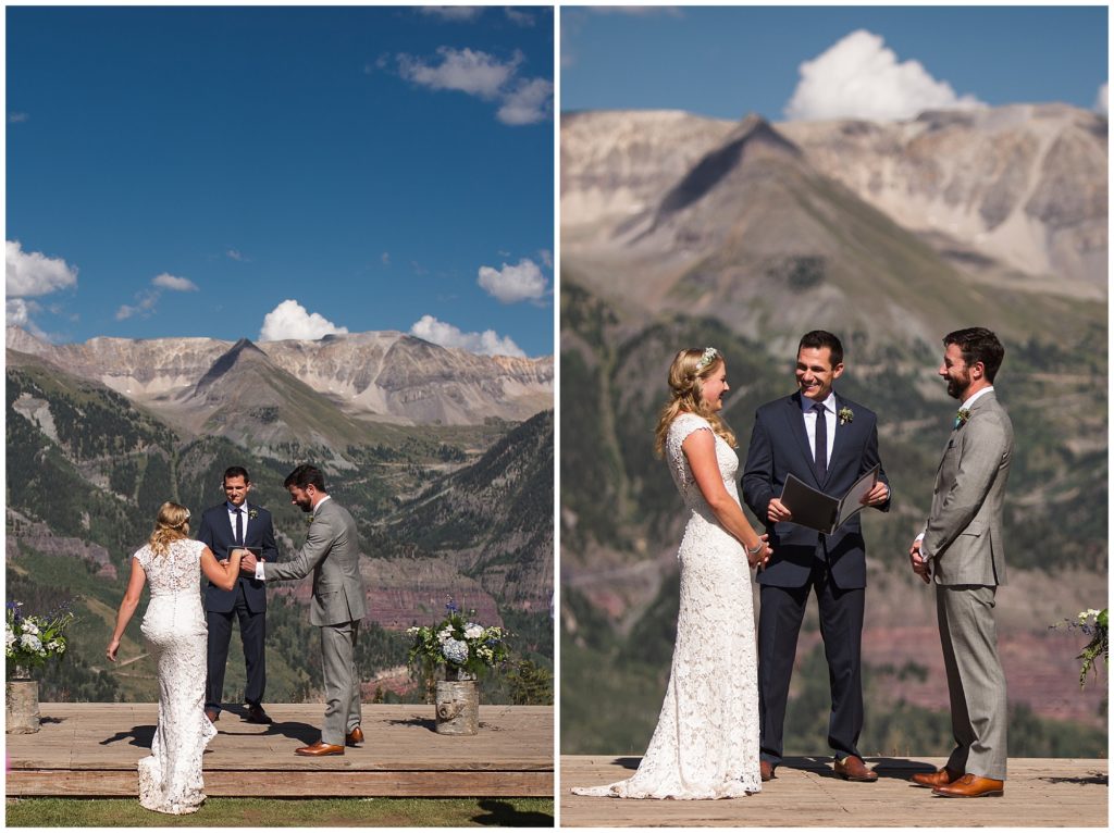 groom helps bride onto stage for their wedding ceremony with stunning mountain backdrop in Telluride