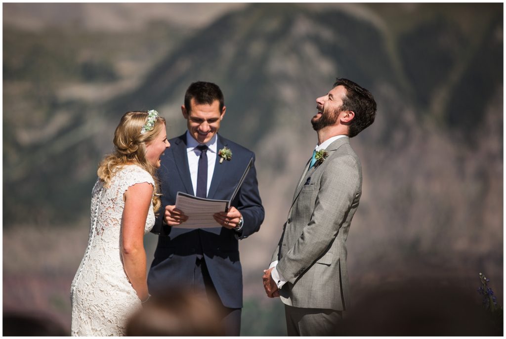 bride and groom laughing during their wedding ceremony at gorrono ranch in Telluride