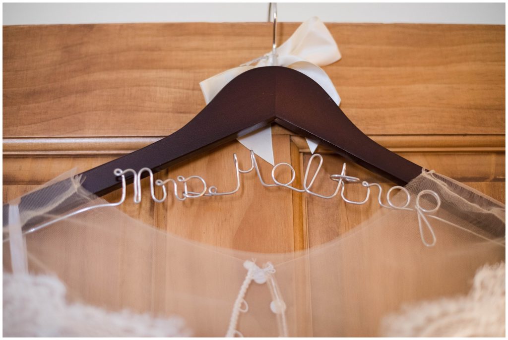 detail of wedding hanger with brides name and white bow in timber ridge lodge in keystone colorado