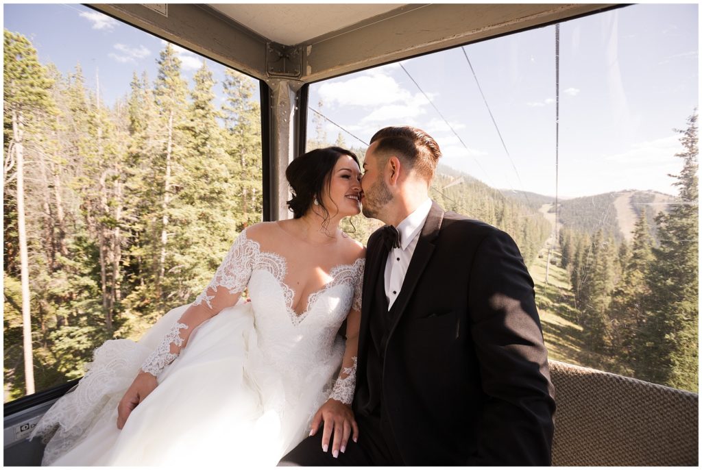 bride and groom kiss inside ski gondola after their first look in timber ridge lodge in keystone colorado