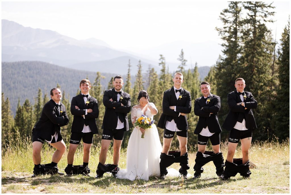 bride covers her eyes in funny picture of groomsmen with their pants down