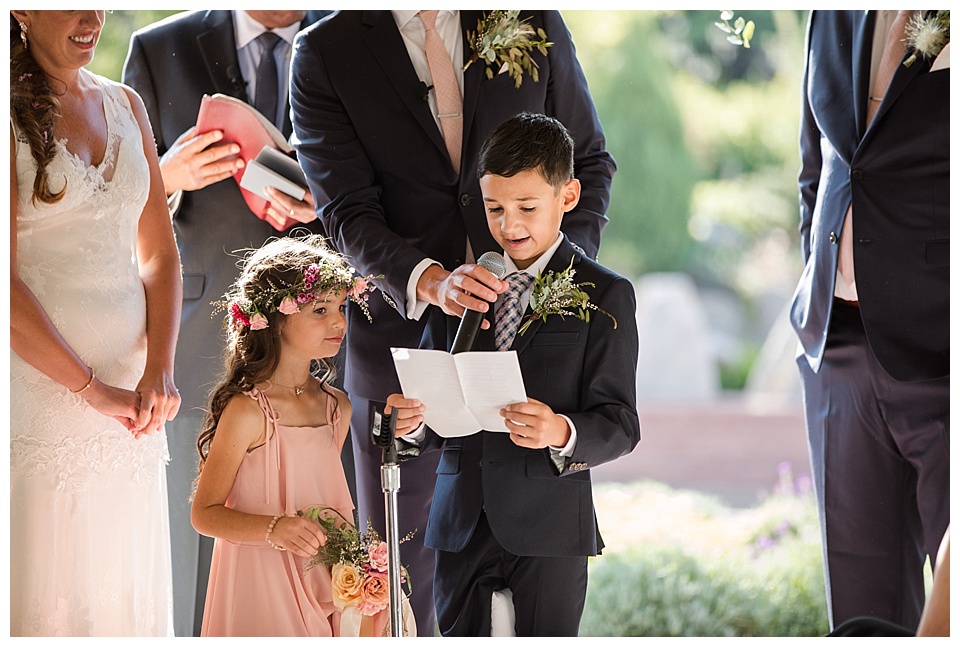 ring bearer does a reading at fathers wedding ceremony