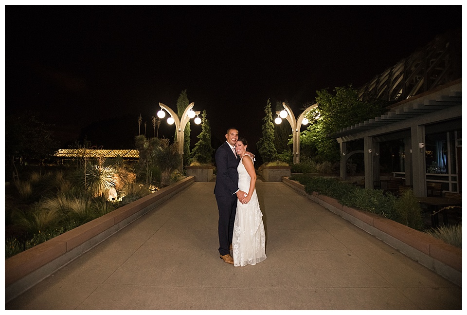 bride and groom pose for night portrait at the end of their wedding day