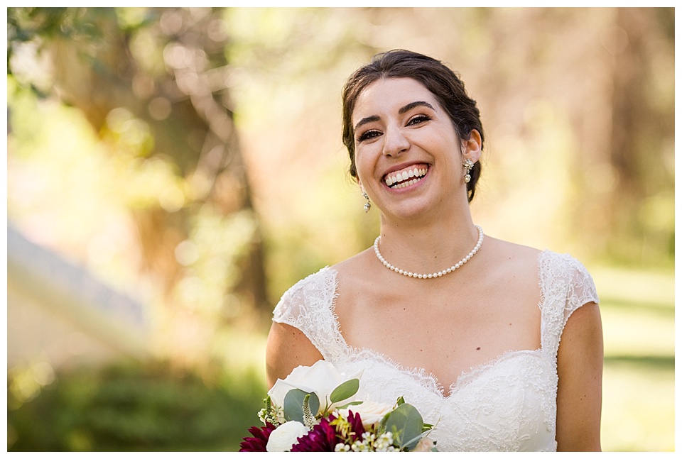 solo shot of bride smiling and laughing with golden light at oxford road farm