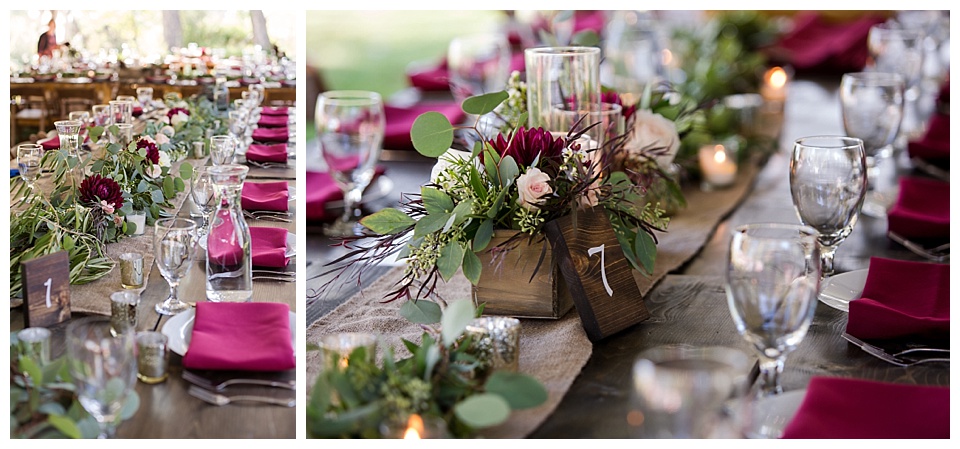 wedding reception details with brown farm tables and numbers red napkins and greenery