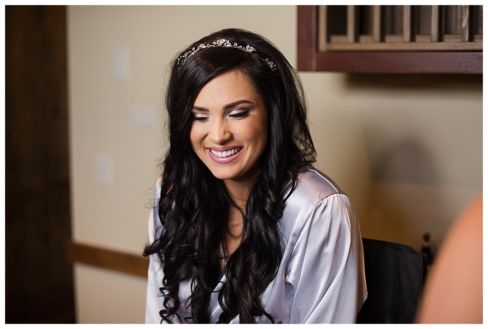bride smiling while getting ready for her wedding day