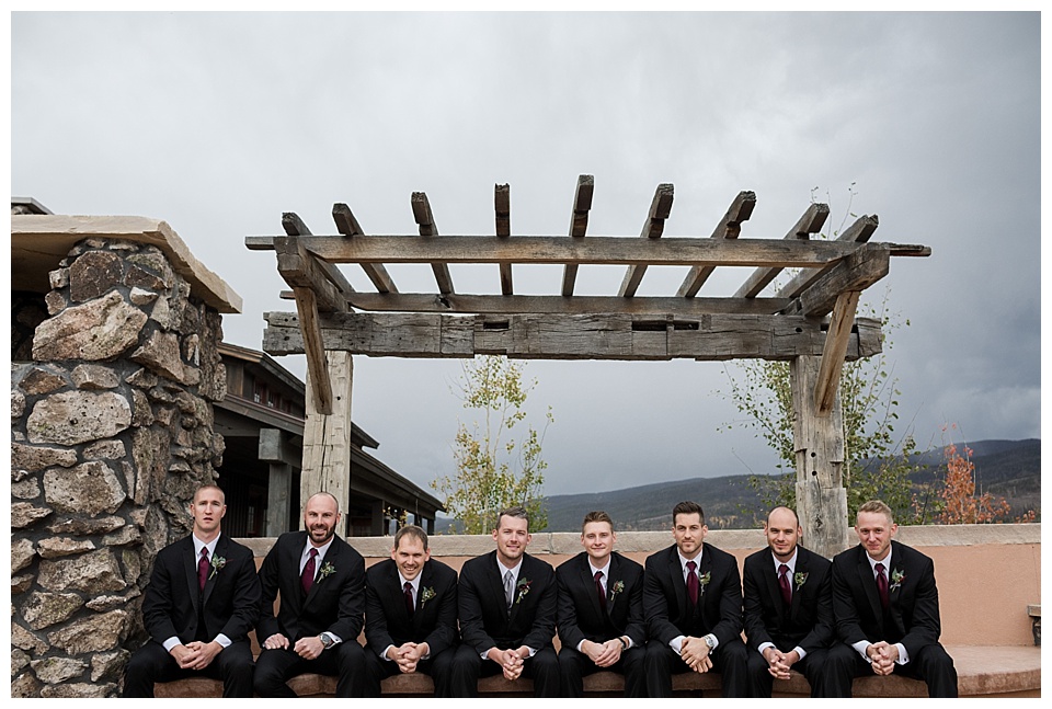 groomsmen posing outside with groom at devils thumb ranch colorado