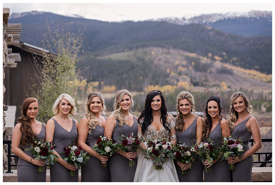 bridesmaids wearing grey pose with bride at devils thumb ranch
