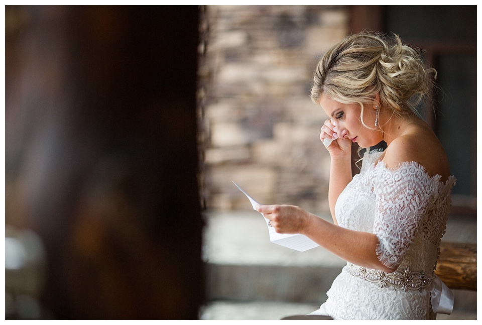 bride crying reading letter from groom before their wedding