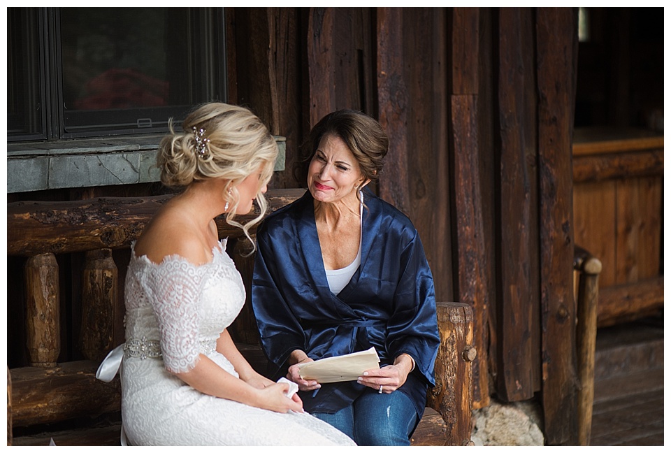 bride and mother crying on wedding day while getting ready