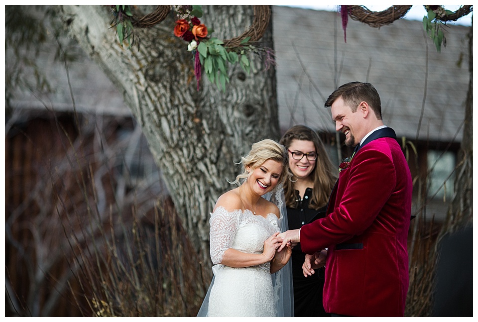 bride and groom laugh during wedding ceremony at spruce mountain ranch