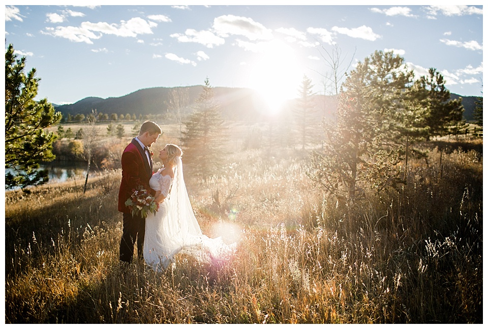 bride and groom look at each other in the meadow at spruce mountain ranch