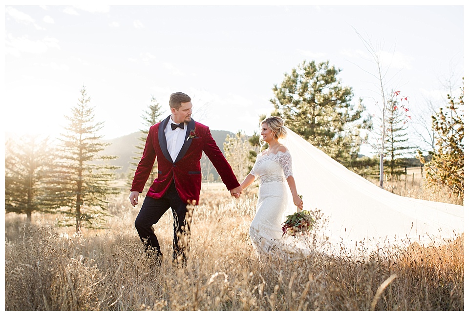 bride and groom walking through the meadow for bridal portraits at spruce mountain ranch 