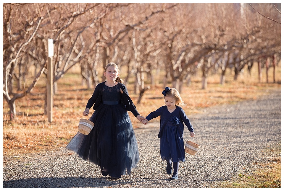 flower girls holding apple baskets at colterris winery 