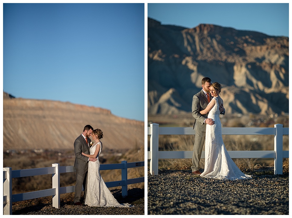 bride and groom pose in front of mountain with blue sky