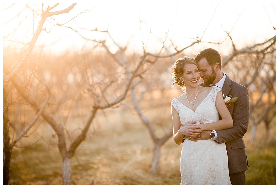 groom holds bride in sunset at colterris winery 