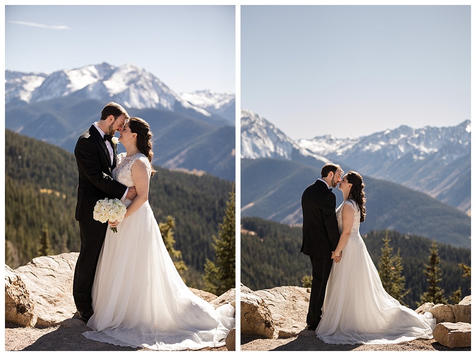 bride and groom hold each other at the top of the mountains in aspen