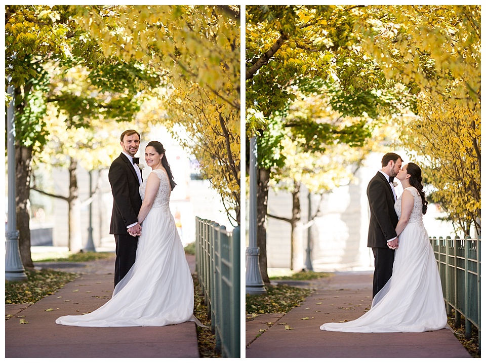 bride and groom take portrait by beautiful yellow fall aspens
