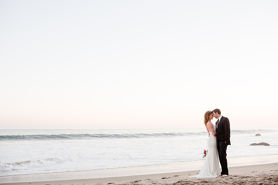 groom and bride kissing at sunset at matador beach