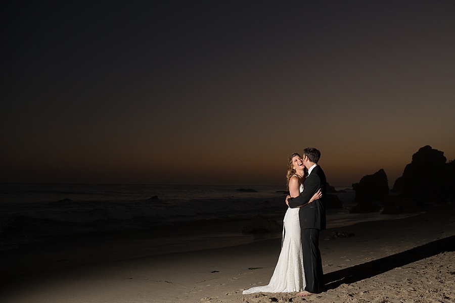 bride and groom posing at dusk at matador beach