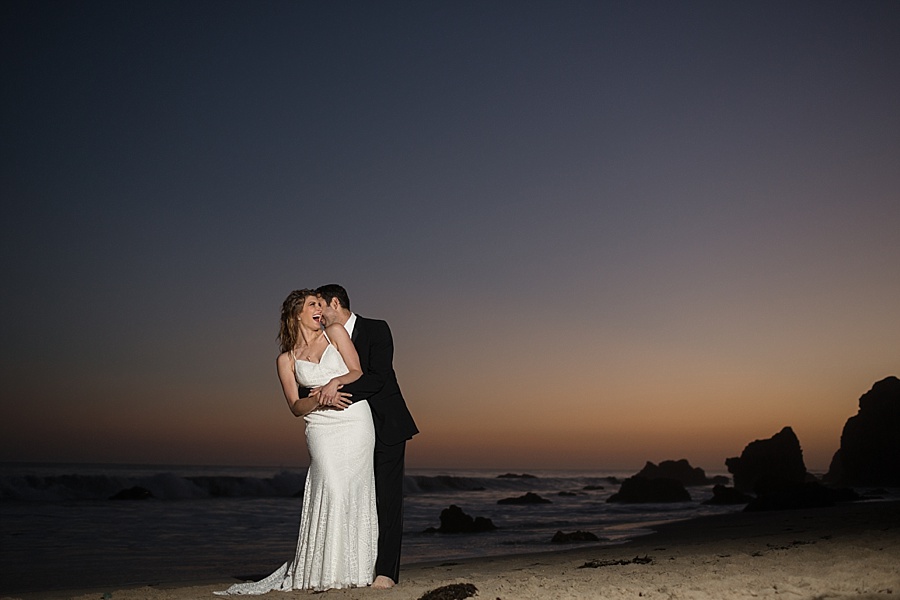 bride and groom snuggle at matador beach
