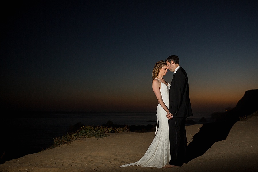 bride and groom touch heads at sunset at matador beach
