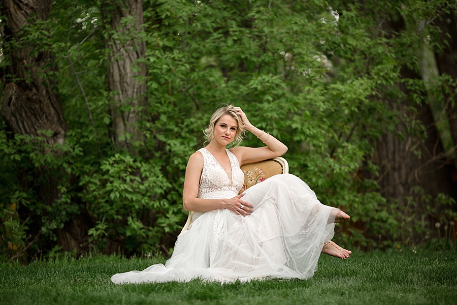 bride poses on chair barefoot at lyons farmette