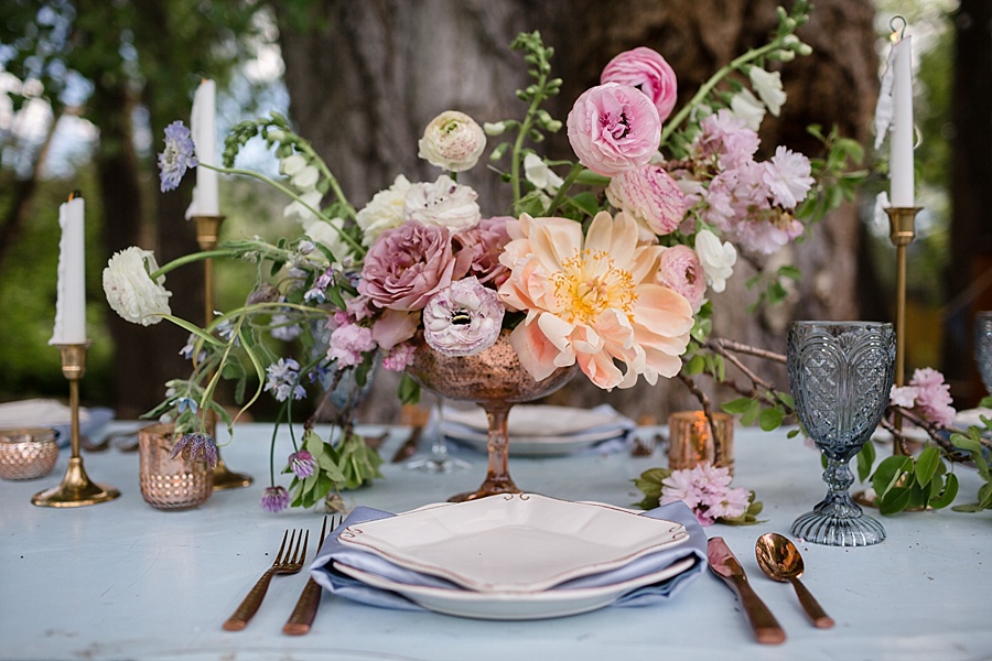 outdoor woods wedding reception table with pastel color scheme