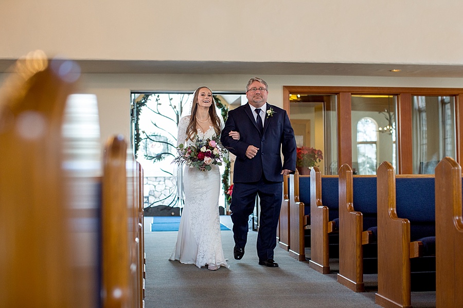 bride escorted by her father down the aisle at beaver creek chapel