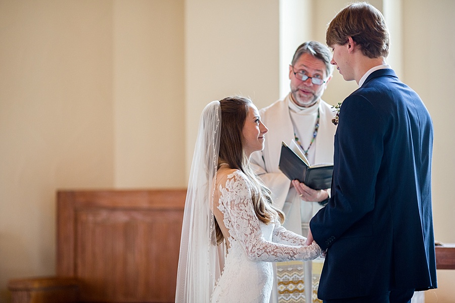 bride and groom exchanging vows during their wedding ceremony at beaver creek chapel