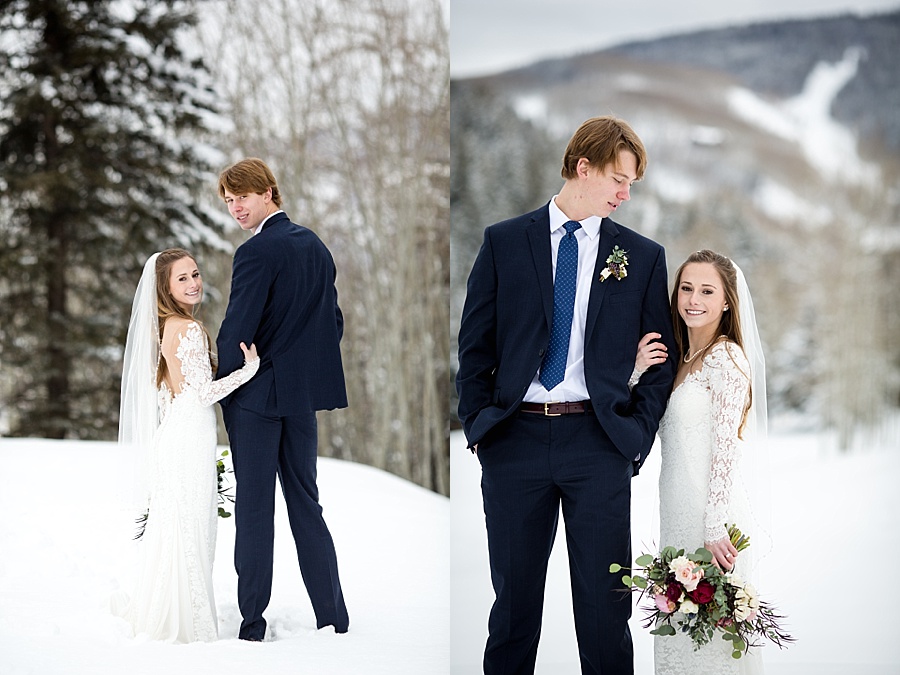 bride holds groom's arm in the snowy colorado mountains