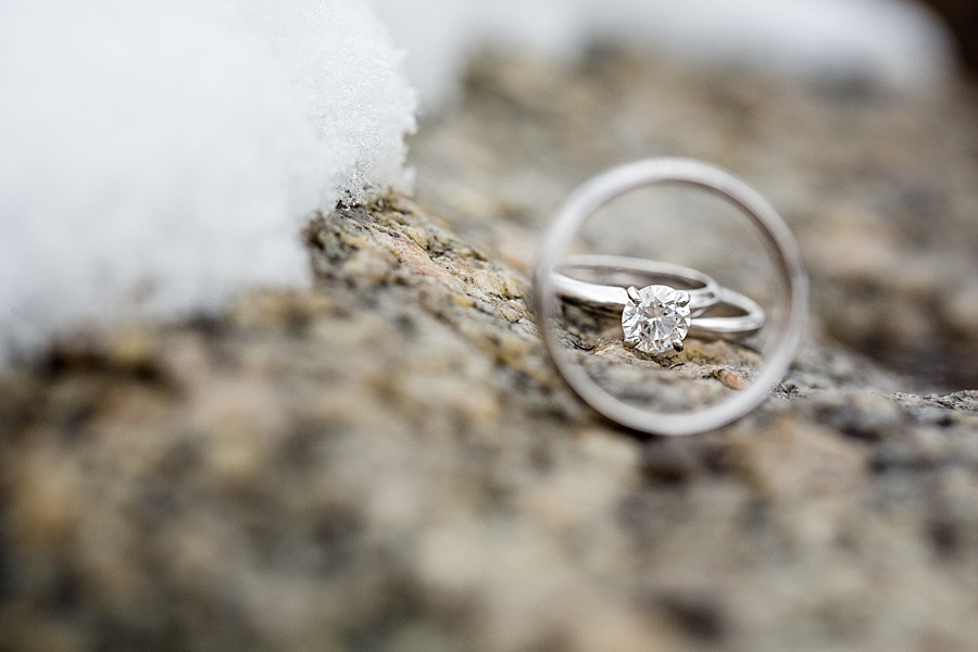detail of silver wedding rings with snow and rocks in beaver creek