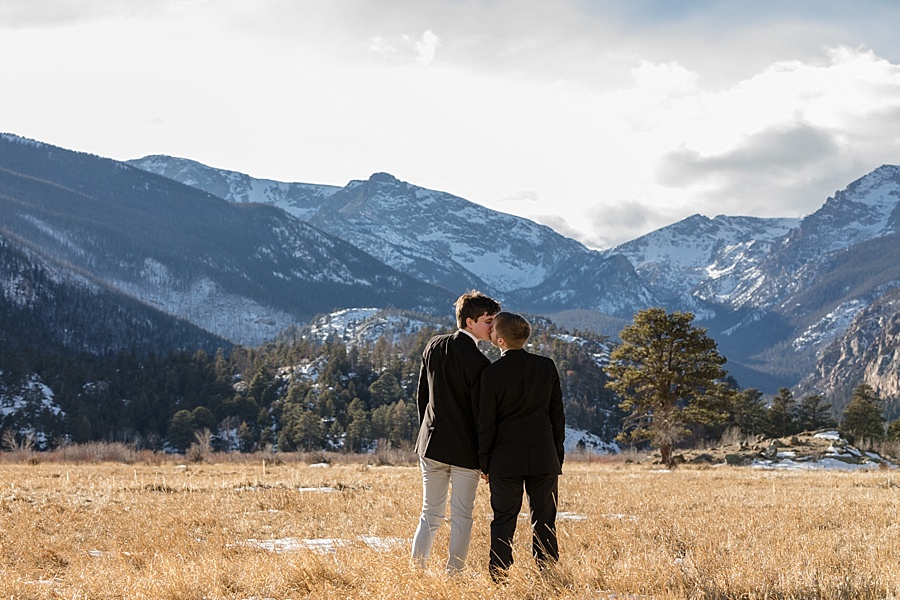 two grooms kissing with mountain backdrop in breckenridge colorado 