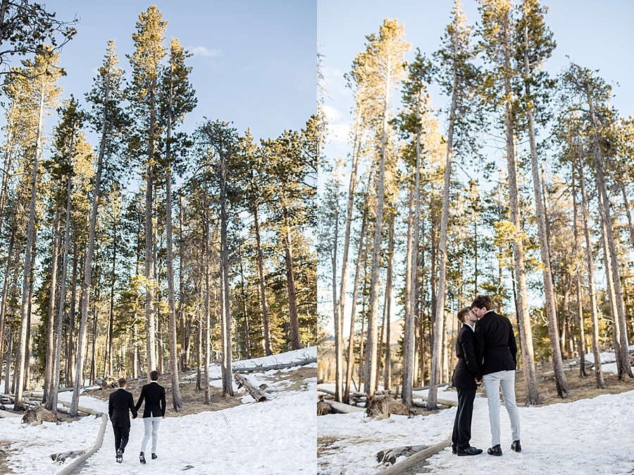 gay couple walks through snowy mountains in breckenridge