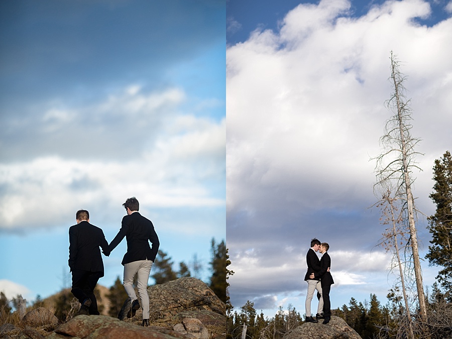 two grooms pose on top of rock in breckenridge colorado 