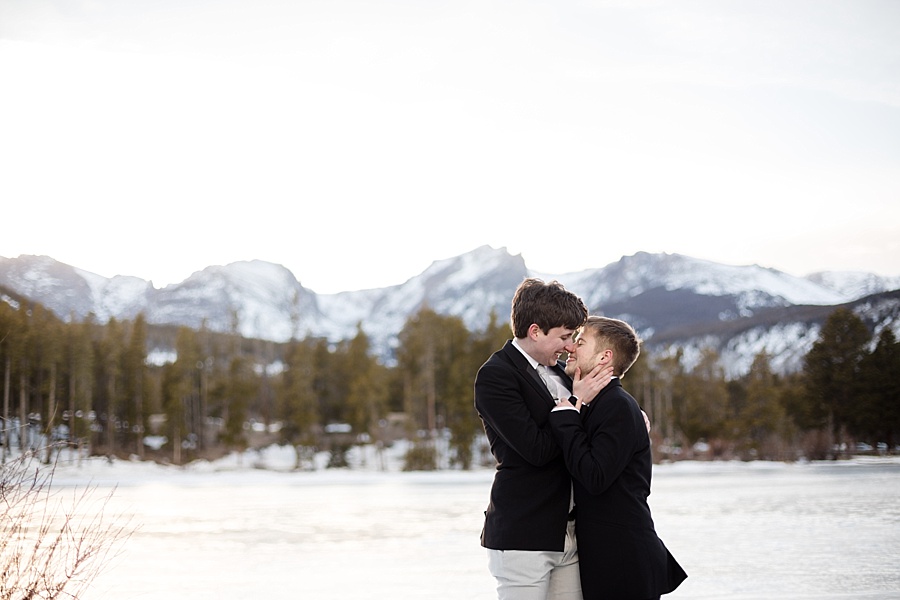 two grooms kiss at lake dillon in the winter after their gay elopement 