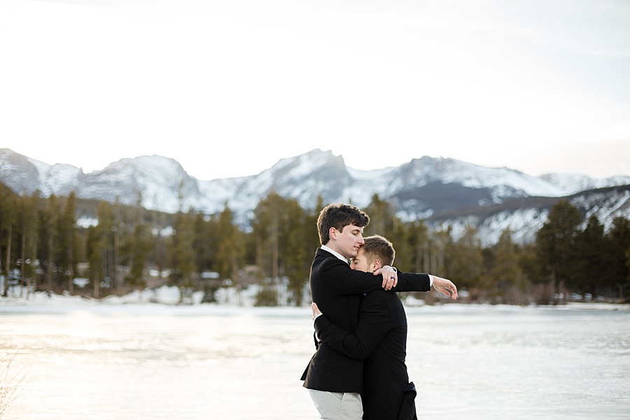 two grooms hug at lake dillon after their gay breckenridge elopement 