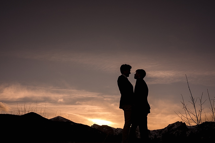 sunset silhouette of two grooms after their gay elopement 