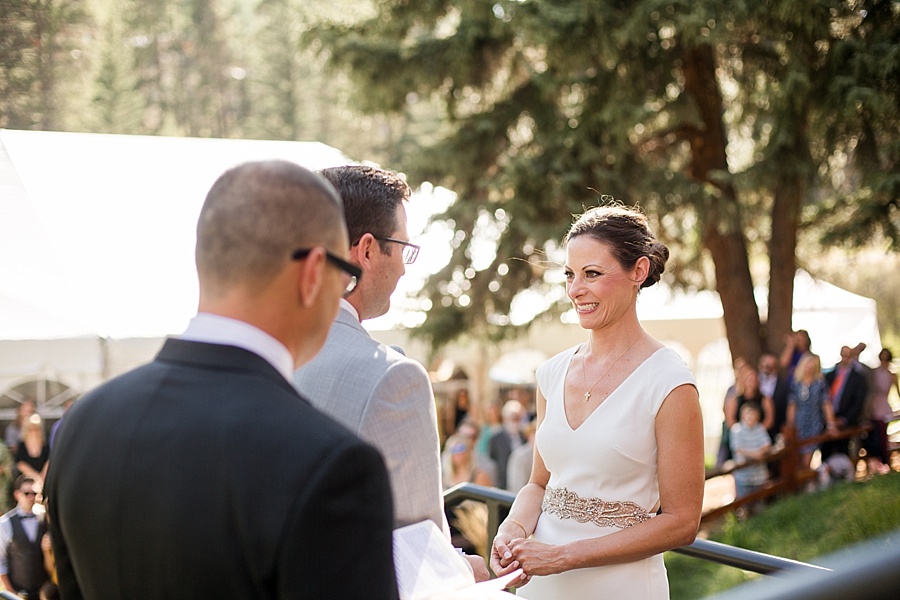 bride smiling during her outdoor summer wedding ceremony at lion square lodge 
